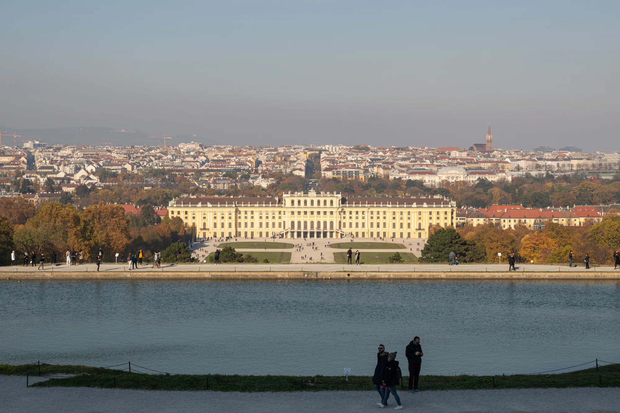 Schönbrunn Palace seen from the Gloriette across the pool and autumn gardens toward Vienna.