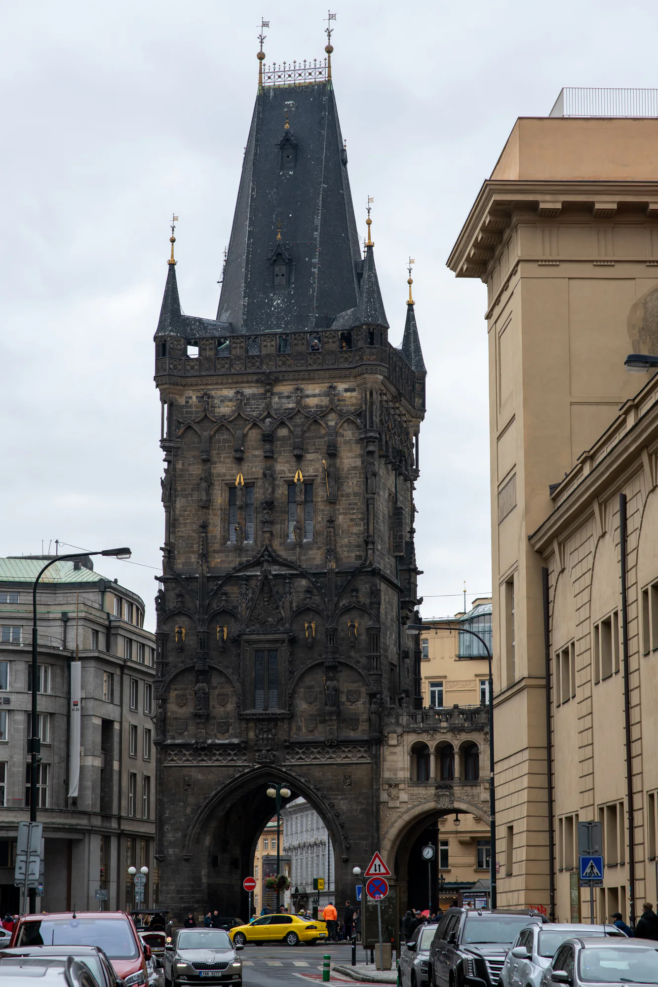 Powder Tower rising above traffic and pedestrians in central Prague, Czech Republic