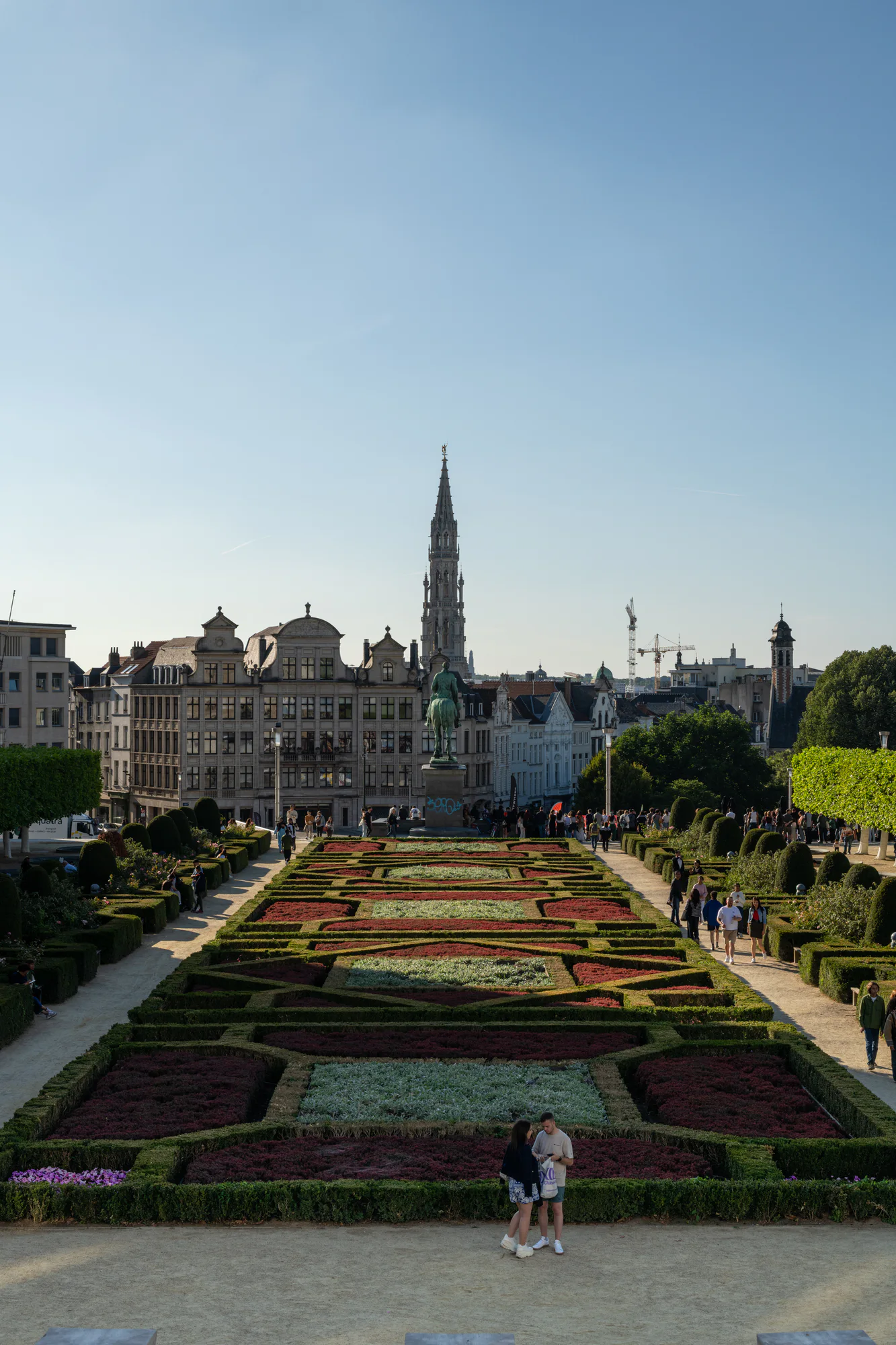 Formal Mont des Arts garden leading toward the Town Hall tower on the Brussels skyline.